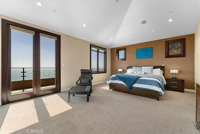 carpeted bedroom with a water view and lofted ceiling