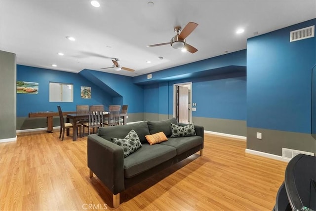 home theater featuring ceiling fan and light hardwood / wood-style floors