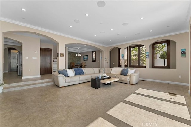 living room featuring crown molding and an inviting chandelier