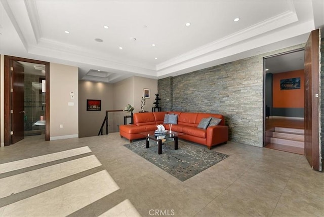 living room featuring a tray ceiling and ornamental molding