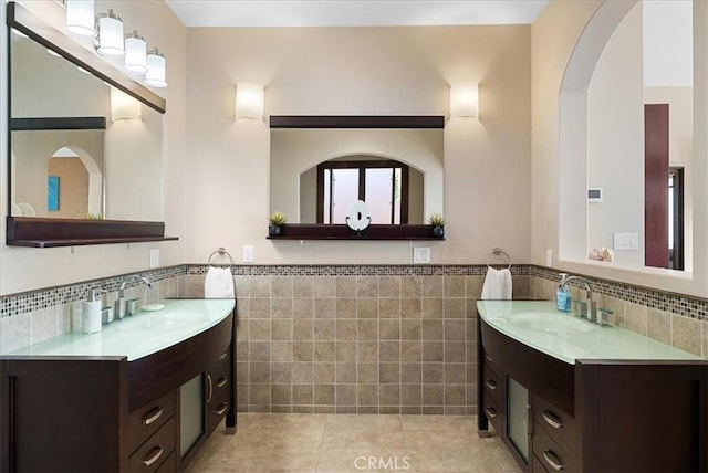 bathroom featuring tile patterned flooring, tile walls, and vanity