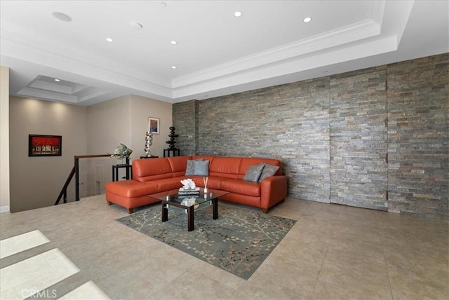 living room with a tray ceiling and ornamental molding