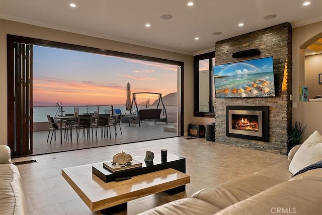 interior space with a stone fireplace and crown molding