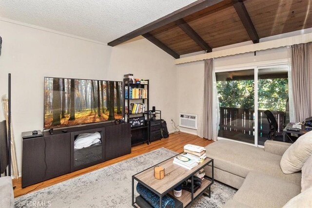 living room featuring hardwood / wood-style floors, vaulted ceiling with beams, a wall mounted air conditioner, a textured ceiling, and wooden ceiling