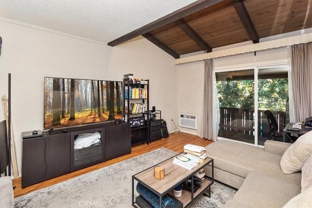 living room featuring a wall mounted air conditioner, vaulted ceiling with beams, hardwood / wood-style flooring, wood ceiling, and a textured ceiling