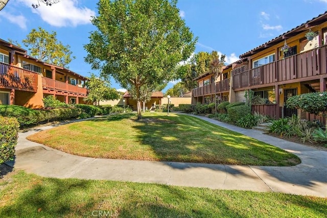 view of property's community with a yard