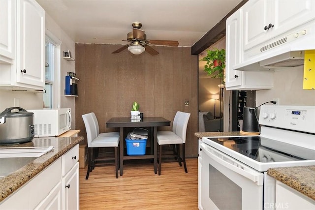 kitchen featuring light hardwood / wood-style flooring, white appliances, white cabinets, ceiling fan, and dark stone countertops