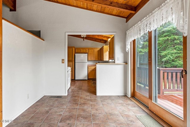 interior space with vaulted ceiling with beams, light tile patterned floors, wood ceiling, and white refrigerator