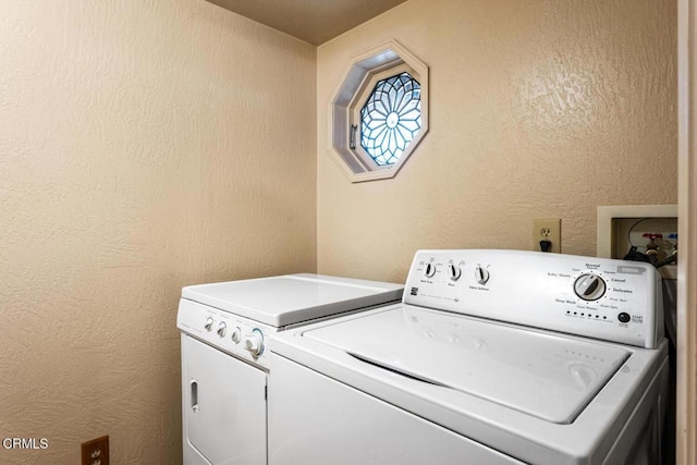 clothes washing area featuring washer and dryer