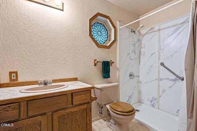 bathroom featuring tile patterned floors, vanity, toilet, and walk in shower