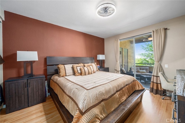 bedroom featuring light hardwood / wood-style floors and access to outside