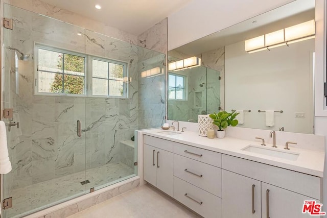 bathroom with a shower with door and vanity