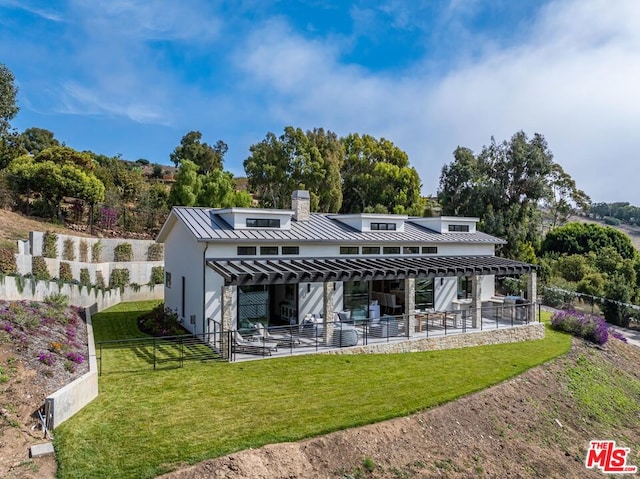 rear view of property featuring a yard, a patio area, and a pergola