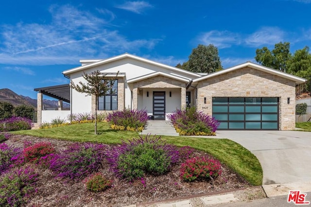 view of front of house featuring a front lawn and a garage