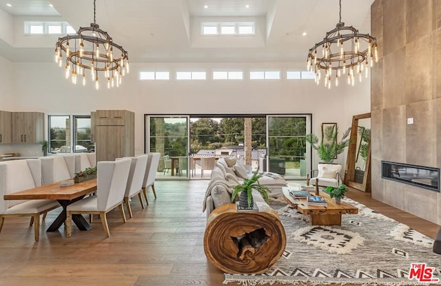 sunroom / solarium featuring a fireplace and an inviting chandelier