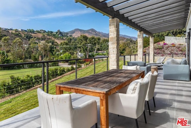 view of patio / terrace featuring an outdoor living space, a mountain view, and a pergola