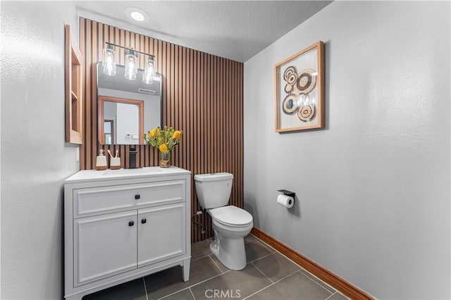 bathroom with tile patterned flooring, vanity, and toilet