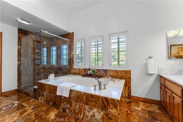 bathroom with vanity and shower with separate bathtub