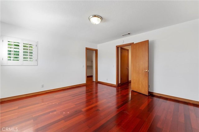 empty room featuring dark hardwood / wood-style flooring