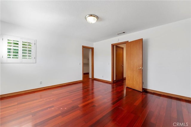 empty room featuring dark hardwood / wood-style flooring