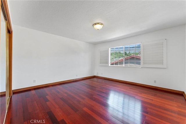 spare room with wood-type flooring