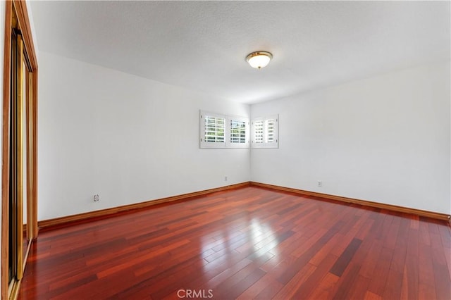 empty room featuring hardwood / wood-style floors and a textured ceiling