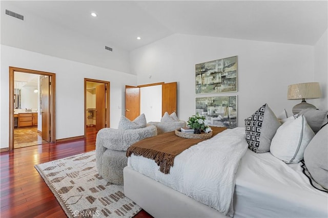 bedroom featuring connected bathroom, hardwood / wood-style floors, and lofted ceiling