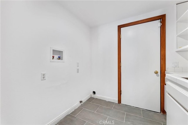 laundry room featuring hookup for a gas dryer, dark tile patterned floors, and washer hookup