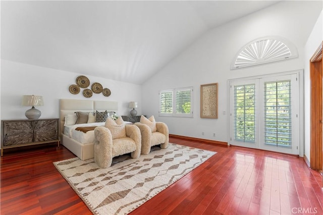 bedroom with access to exterior, high vaulted ceiling, multiple windows, and dark wood-type flooring