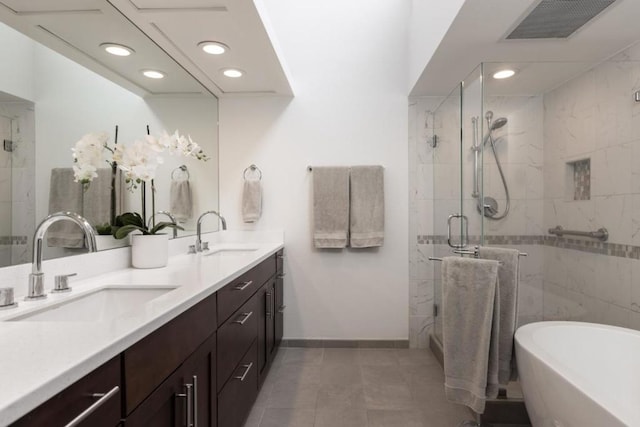 bathroom with tile patterned floors, vanity, and plus walk in shower