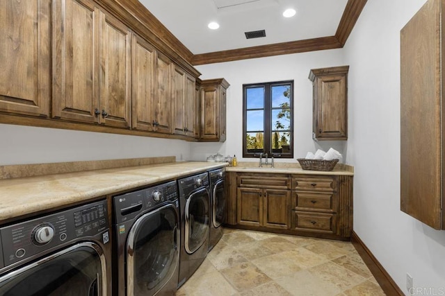 clothes washing area featuring sink, cabinets, ornamental molding, and washer and dryer