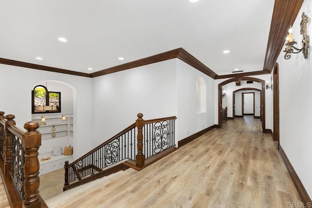 hall with crown molding and light hardwood / wood-style flooring