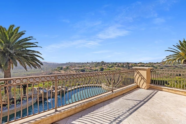 balcony featuring a water view and a patio area