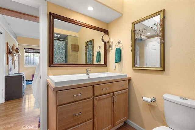 bathroom with vanity, wood-type flooring, and toilet