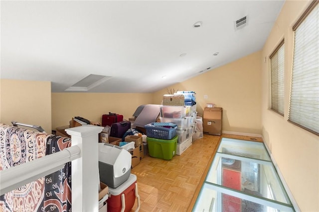 bonus room with lofted ceiling and light parquet floors