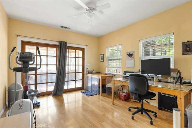 office with ceiling fan and light hardwood / wood-style floors