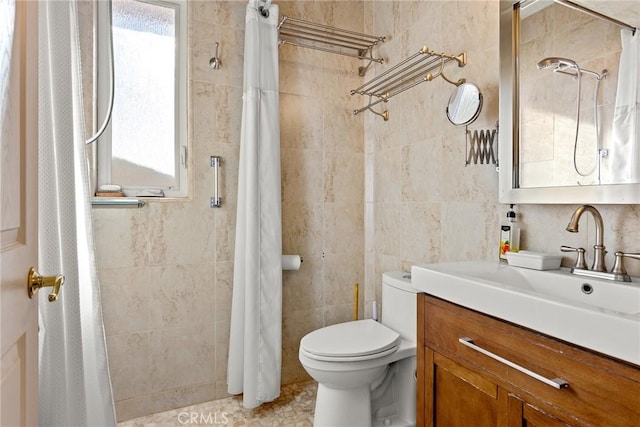 bathroom featuring vanity, toilet, tile walls, and walk in shower