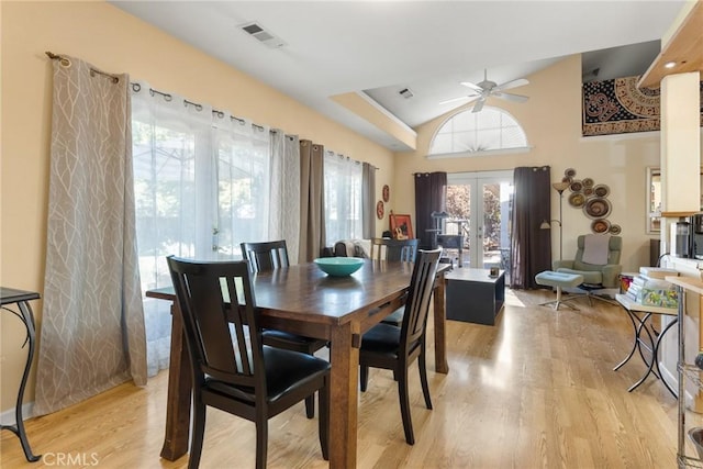 dining room with french doors, light hardwood / wood-style flooring, ceiling fan, and lofted ceiling