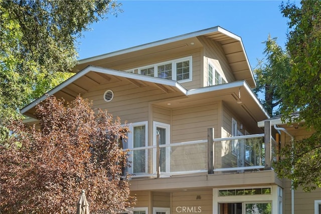 view of side of home featuring a balcony