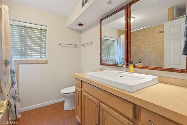 bathroom featuring tile patterned floors, walk in shower, vanity, and toilet