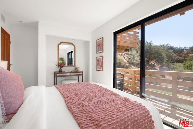 bedroom featuring access to outside and multiple windows