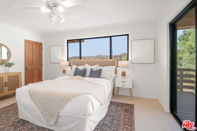 bedroom featuring ceiling fan and access to exterior