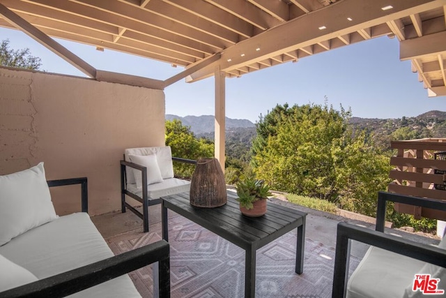 balcony with an outdoor living space and a mountain view