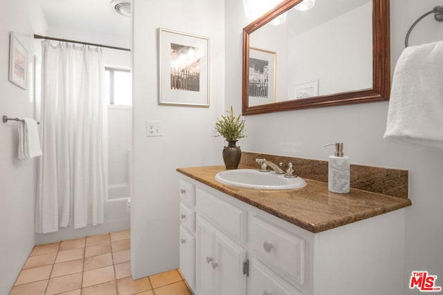 bathroom featuring vanity, shower / tub combo with curtain, and tile patterned flooring