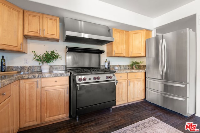 kitchen featuring light brown cabinets, appliances with stainless steel finishes, dark hardwood / wood-style flooring, and wall chimney range hood