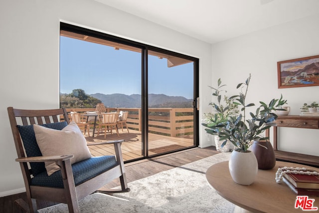 interior space with a mountain view and light wood-type flooring