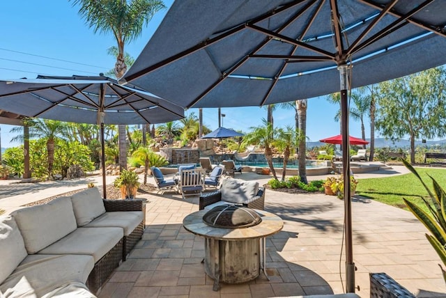 view of patio featuring an outdoor living space with a fire pit