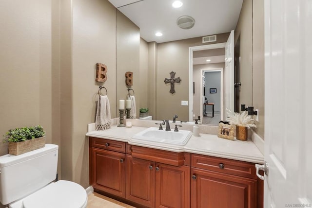 bathroom featuring vanity and toilet