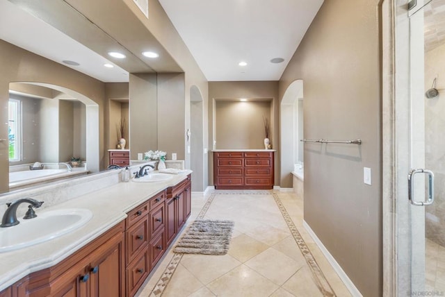 bathroom featuring tile patterned flooring, vanity, and separate shower and tub