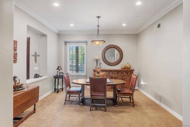 carpeted dining area with crown molding